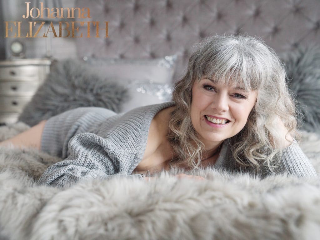 Confident, smiling lady during a boudoir photoshoot